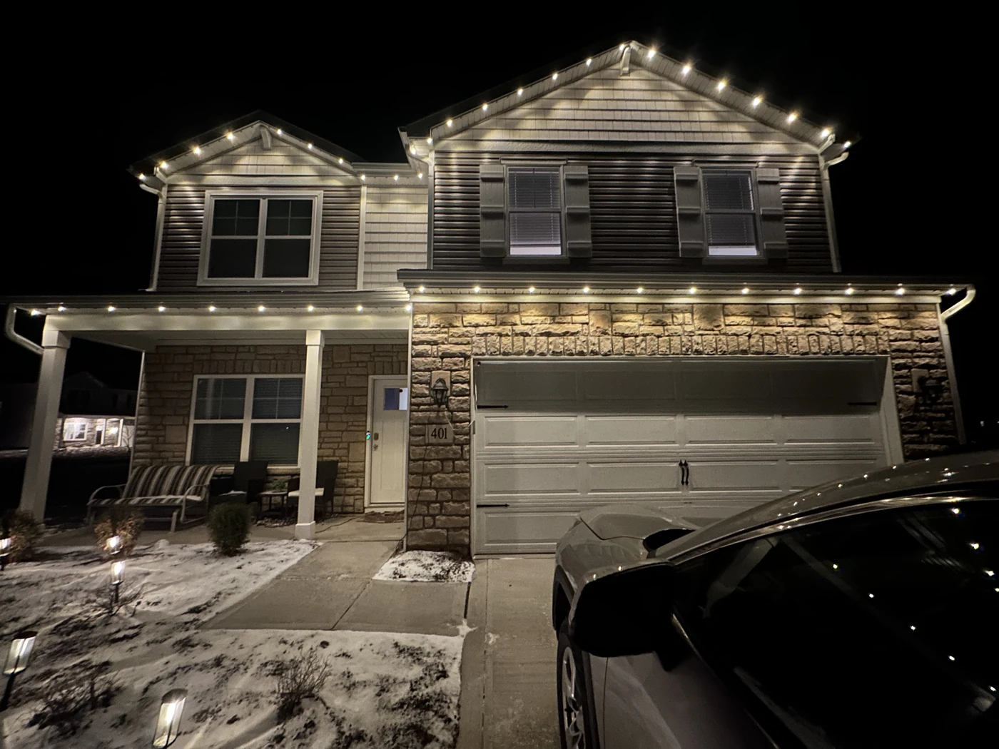 105 ft two-story home in Plain City, OH with warm white permanent Christmas lights at night