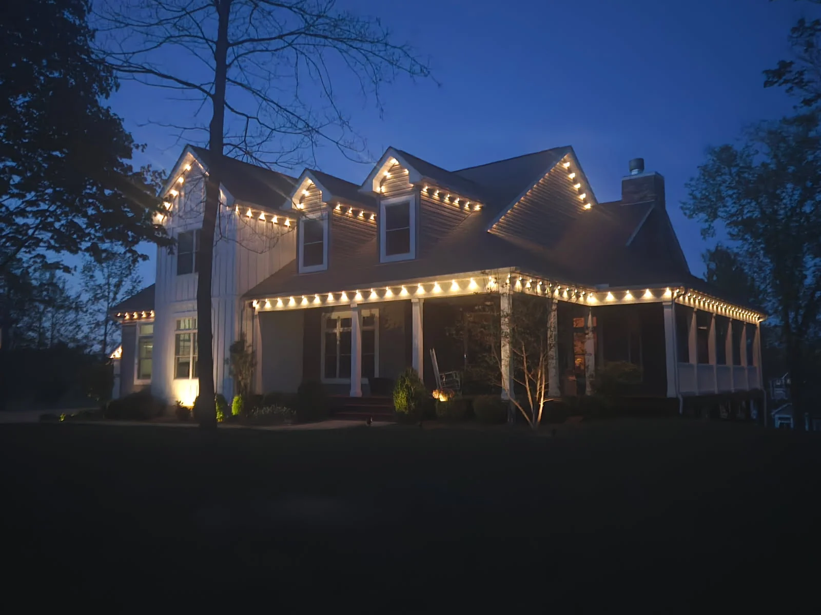 333 ft Columbus farmhouse side view at twilight, Govee permanent lights along porch and roofline