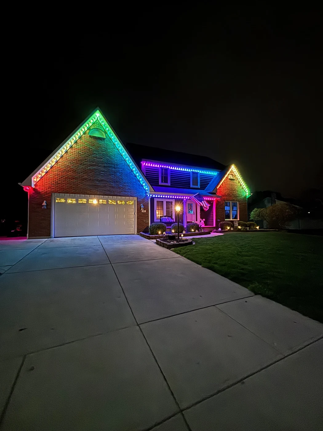 Purple permanent lights on two story home at night