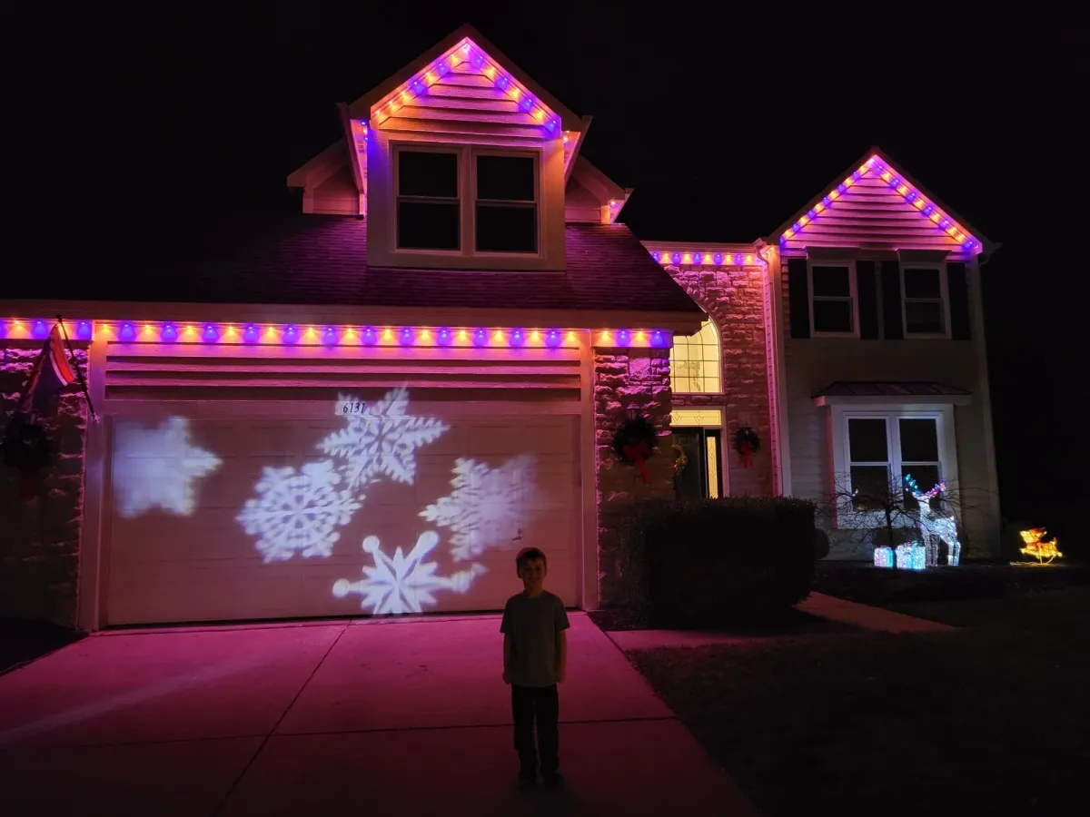 Warm white permanent lights on craftsman home at night